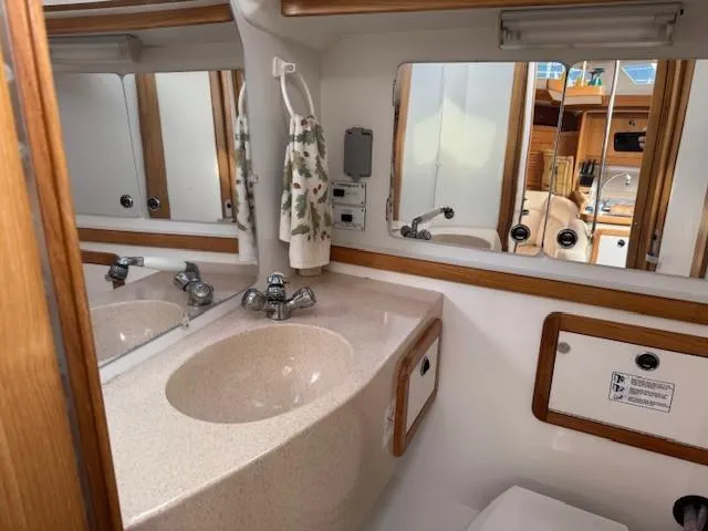 Maxwell Yacht Photos Pics Bathroom interior of 2001 Catalina 42 MkII yacht, featuring sink and mirror.
