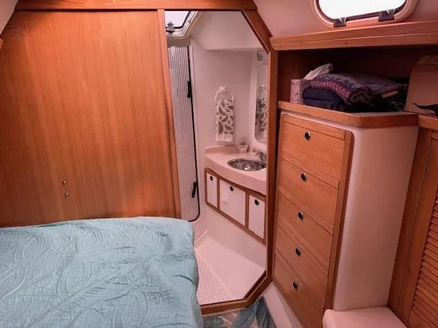 Maxwell Yacht Photos Pics Interior of 2001 Catalina 42 MkII sailboat with wood cabinetry and compact bathroom.