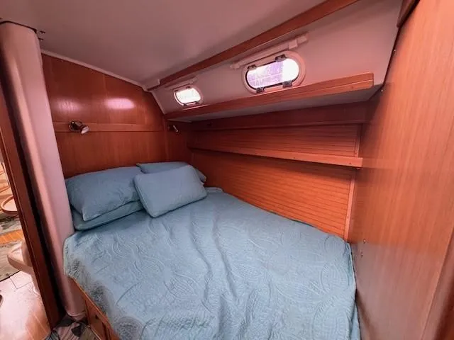 Maxwell Yacht Photos Pics Cozy cabin interior of 2001 Catalina 42 MkII sailboat with blue bedding.