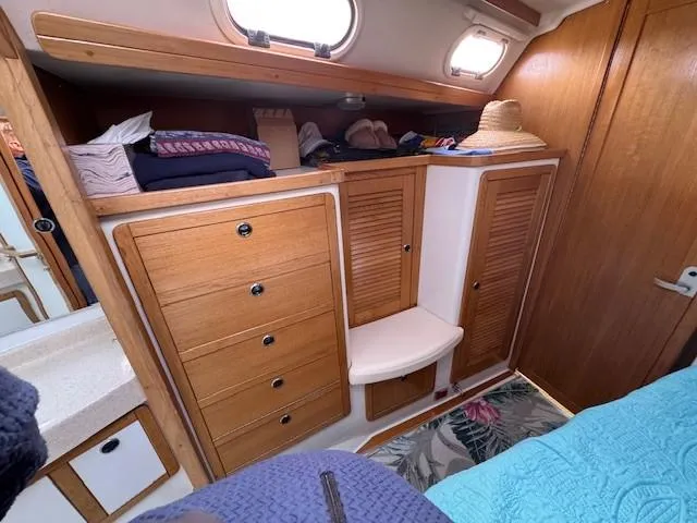 Maxwell Yacht Photos Pics Interior of 2001 Catalina 42 MkII sailboat with wooden cabinets and cozy bedding.
