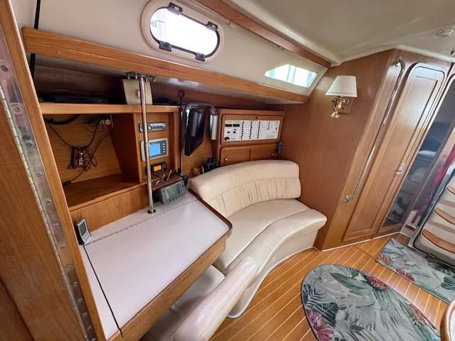 Maxwell Yacht Photos Pics Interior of 2001 Catalina 42 MkII sailboat with navigation station and seating area.