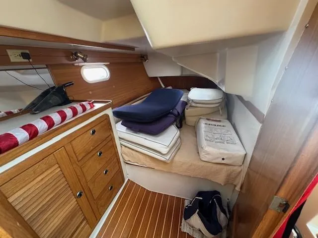 Maxwell Yacht Photos Pics Interior cabin of 2001 Catalina 42 MkII sailboat with wooden cabinetry and bedding.