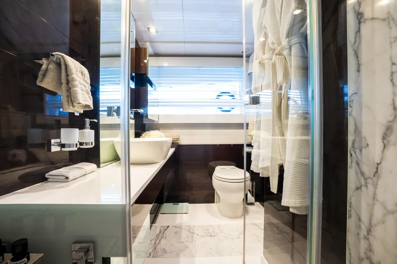 Omnia Yacht Photos Pics Luxurious bathroom in 2018 Pearl 80 yacht with modern fixtures and marble accents.
