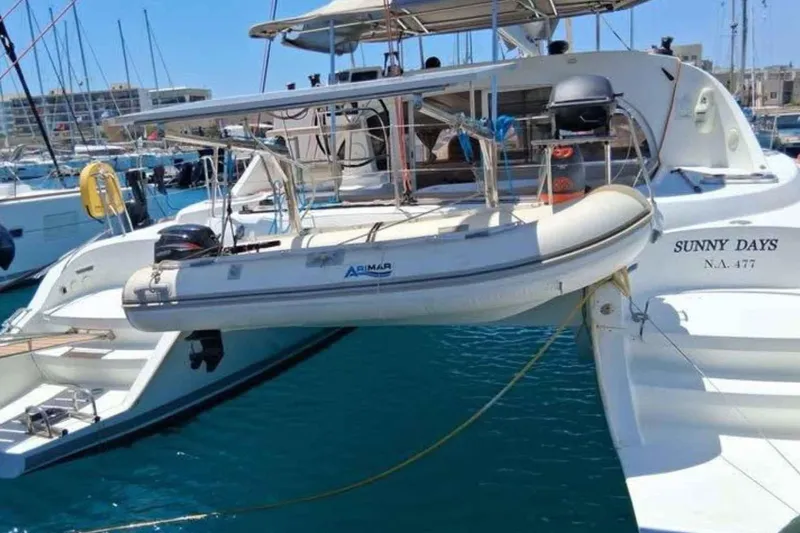 Sunny Days Yacht Photos Pics 2013 Lagoon 380 S2 catamaran "Sunny Days" docked with tender boat.