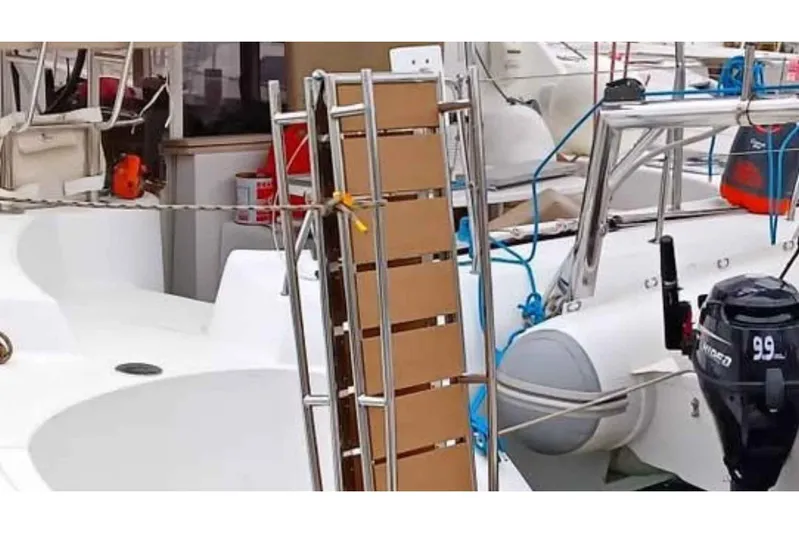 Sunny Days Yacht Photos Pics 2013 Lagoon 380 S2 catamaran with outboard motor and boarding ladder.