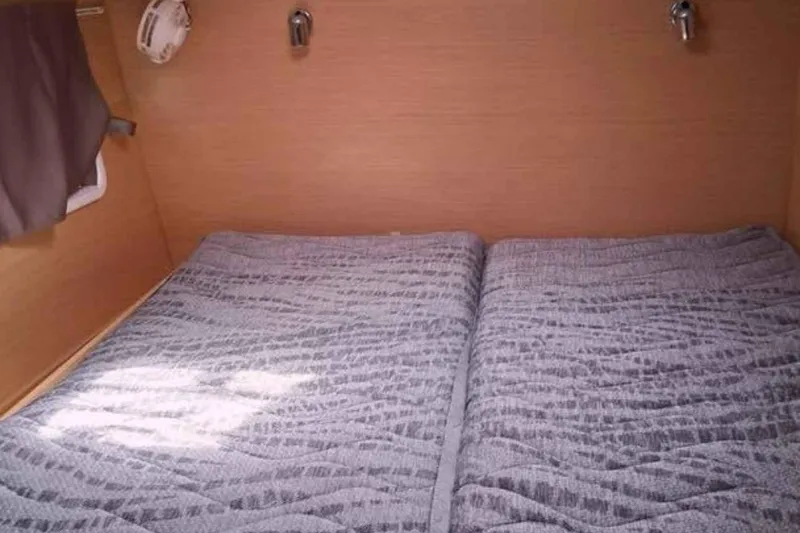 Sunny Days Yacht Photos Pics Cozy cabin interior of 2013 Lagoon 380 S2 catamaran with twin beds and wooden paneling.