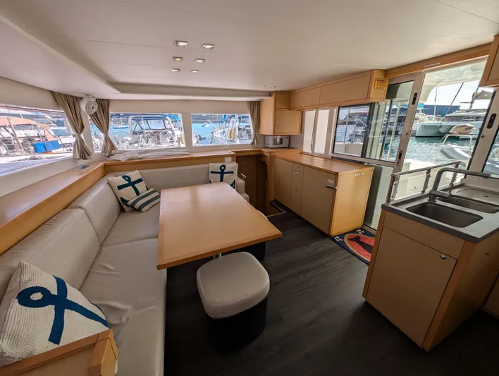 Southern Charm Yacht Photos Pics Spacious interior of 2015 Lagoon 450 F catamaran with modern kitchen and seating area.