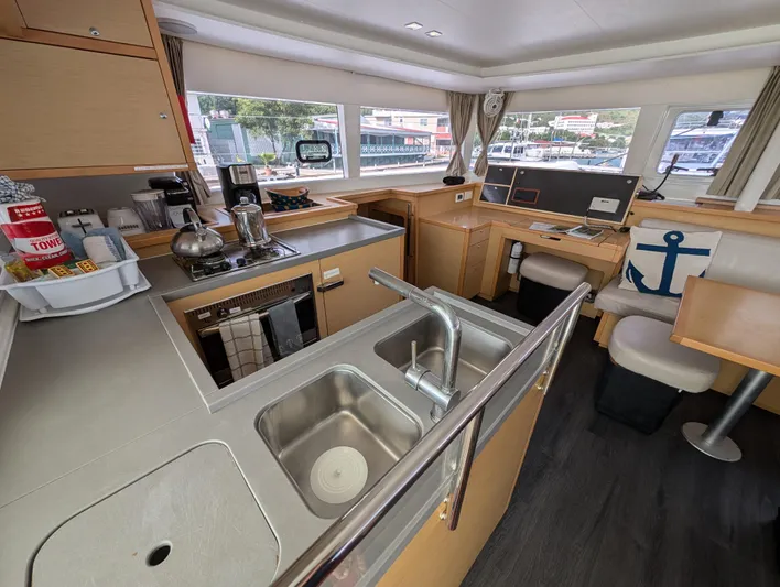Southern Charm Yacht Photos Pics Interior of 2015 Lagoon 450 F catamaran with modern kitchen and dining area.