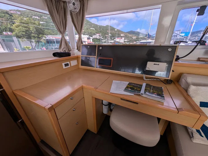 Southern Charm Yacht Photos Pics Interior of 2015 Lagoon 450 F yacht with navigation desk and scenic window view.