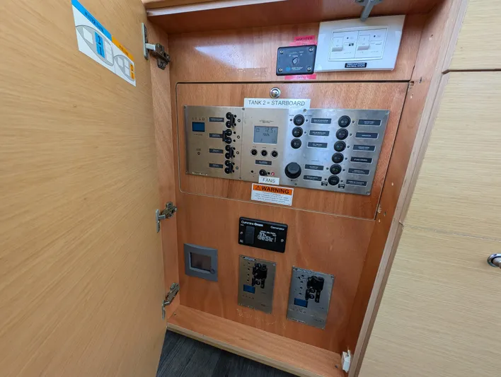 Southern Charm Yacht Photos Pics Electrical control panel inside a 2015 Lagoon 450 F yacht, featuring various switches and displays.