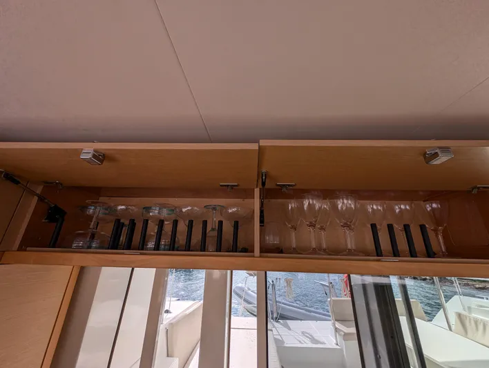 Southern Charm Yacht Photos Pics Cabinet with glassware on a 2015 Lagoon 450 F yacht interior.