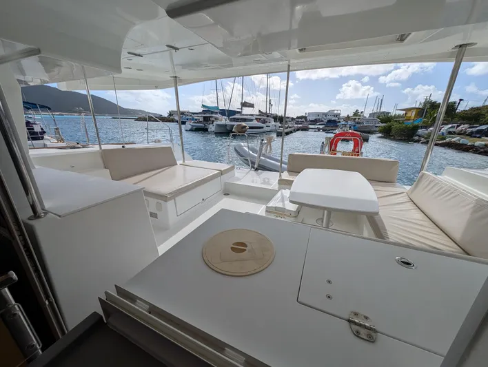 Southern Charm Yacht Photos Pics Spacious deck of 2015 Lagoon 450 F catamaran in marina setting.