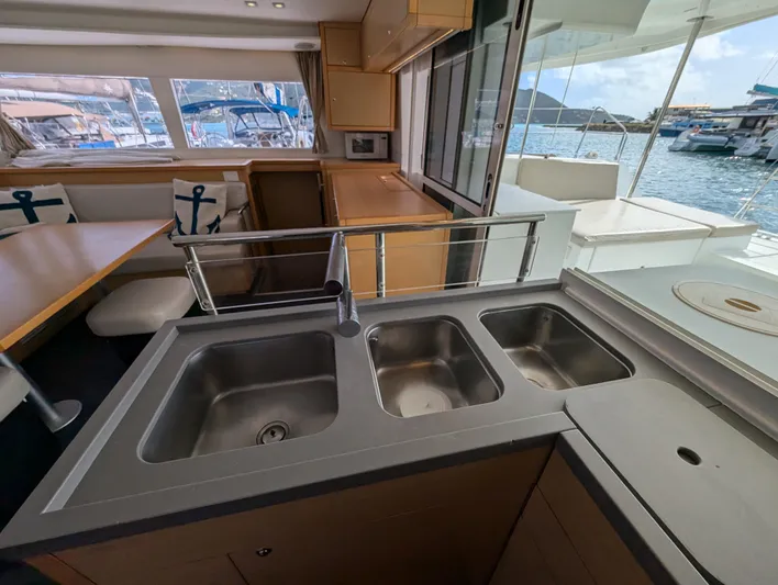 Southern Charm Yacht Photos Pics Interior of 2015 Lagoon 450 F yacht with modern kitchen and marina view.
