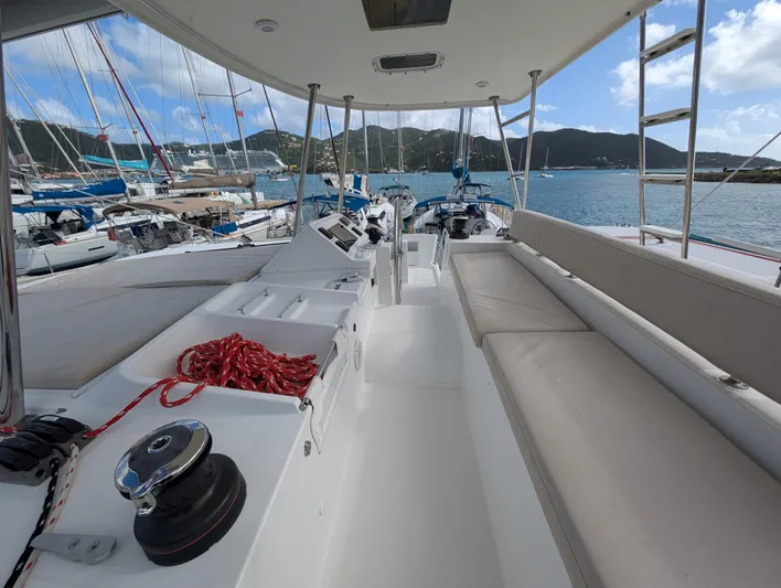 Southern Charm Yacht Photos Pics Lagoon 450 F catamaran deck with seating, docked in a scenic marina, 2015 model.