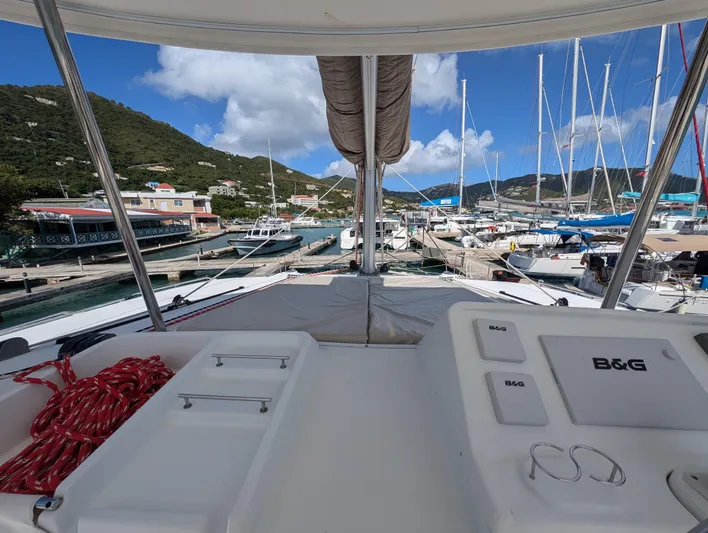 Southern Charm Yacht Photos Pics 2015 Lagoon 450 F catamaran docked at a marina with scenic mountain backdrop.