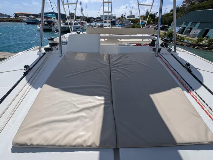 Southern Charm Yacht Photos Pics 2015 Lagoon 450 F catamaran with sunbathing deck, docked at marina.