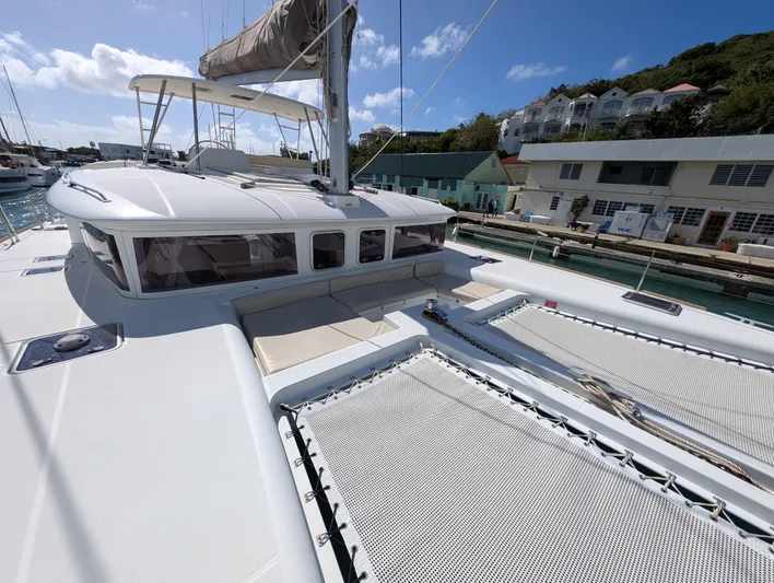 Southern Charm Yacht Photos Pics 2015 Lagoon 450 F catamaran docked at marina under clear blue sky.