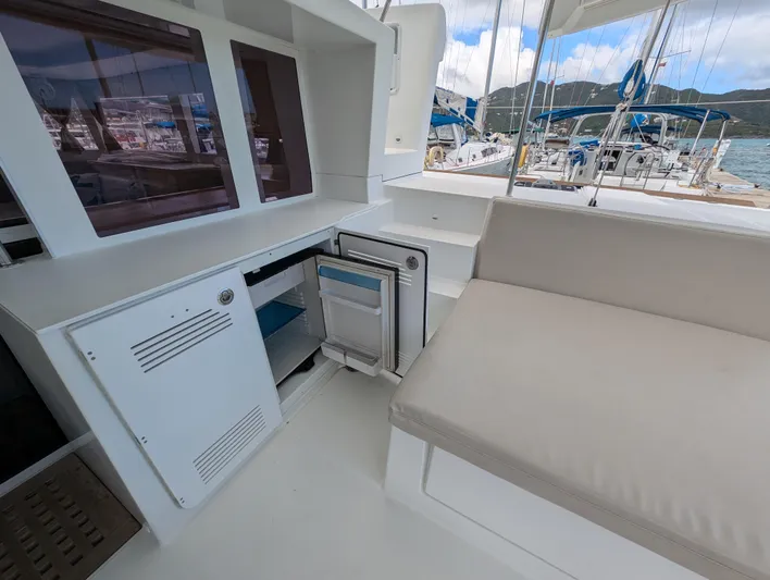 Southern Charm Yacht Photos Pics 2015 Lagoon 450 F yacht interior with seating and storage, docked at marina.