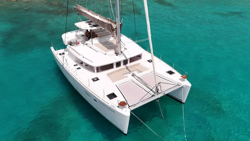 Southern Charm Yacht Photos Pics 2015 Lagoon 450 F catamaran sailing on clear turquoise waters.