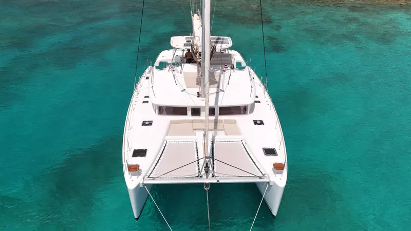 Southern Charm Yacht Photos Pics 2015 Lagoon 450 F catamaran on clear turquoise water, aerial view.