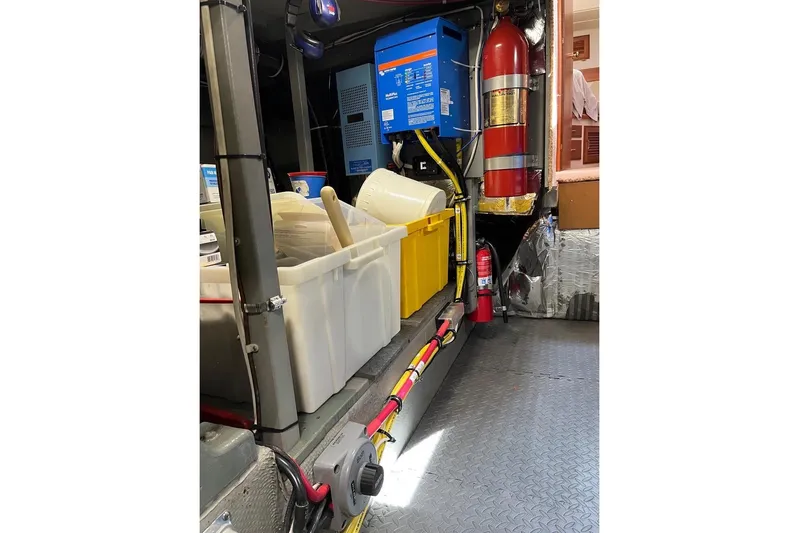 Venture 1 Yacht Photos Pics Engine room of 1985 Tollycraft 43 with equipment and storage containers.