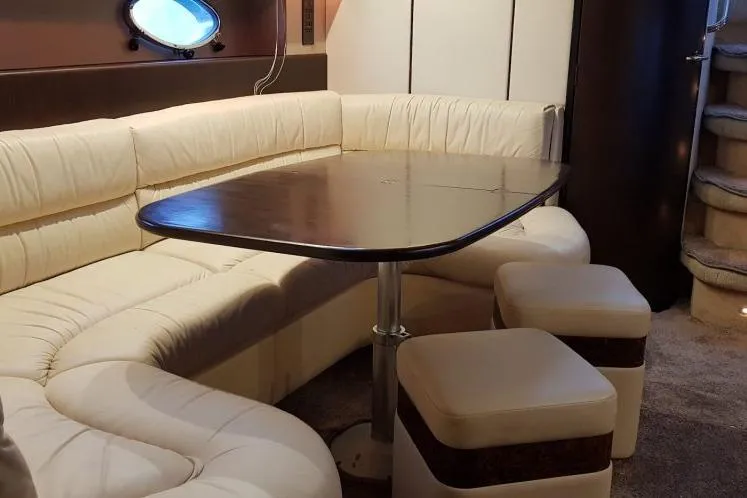  Yacht Photos Pics Luxurious interior of a 1996 Princess V52 yacht with cream leather seating and wooden table.
