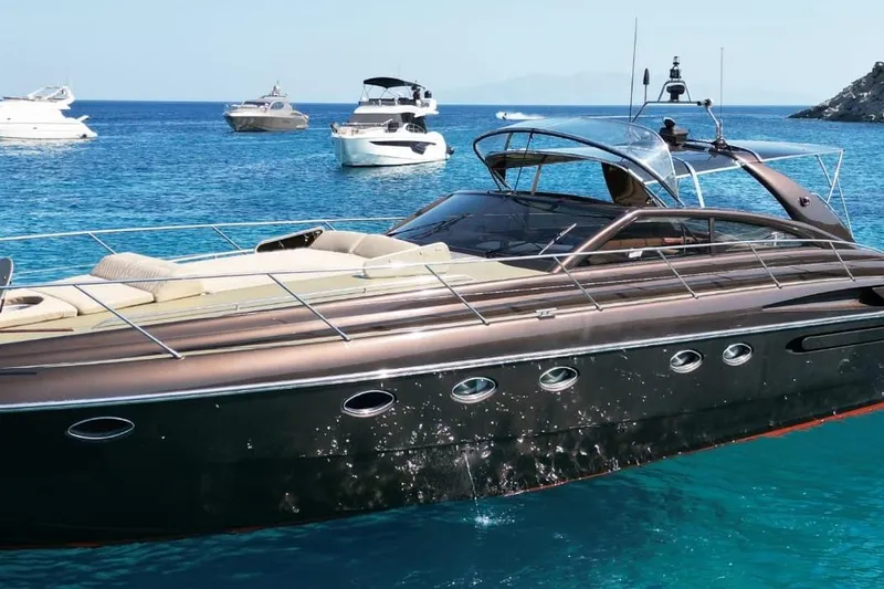  Yacht Photos Pics Luxurious 1996 Princess V52 yacht cruising in clear blue waters, surrounded by other boats.