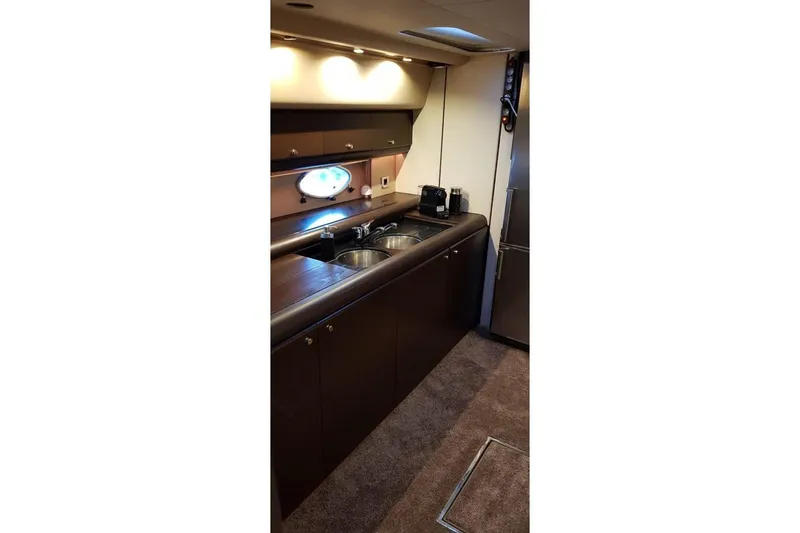  Yacht Photos Pics Luxurious kitchen interior of a 1996 Princess V52 yacht with modern amenities.