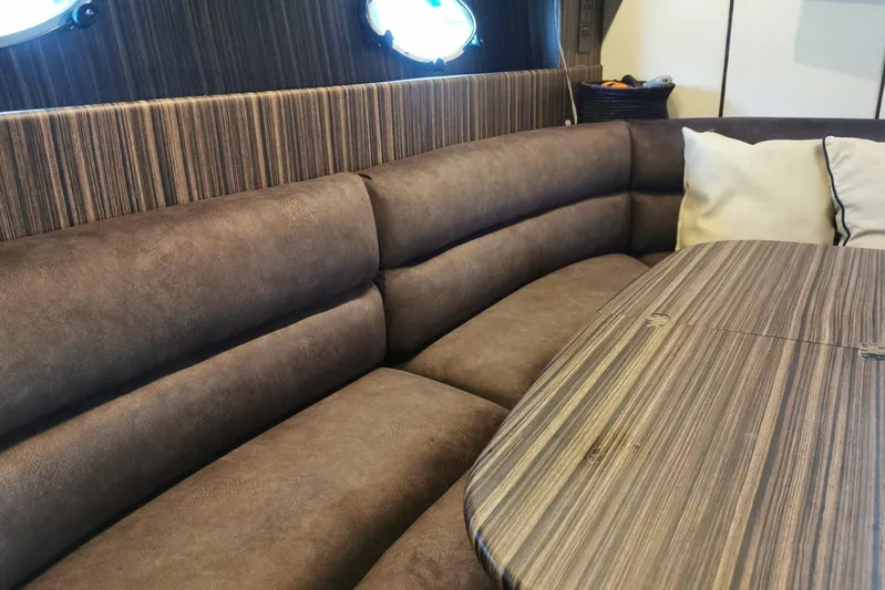 Yacht Photos Pics Luxurious interior of 1996 Princess V52 yacht with plush seating and wooden table.
