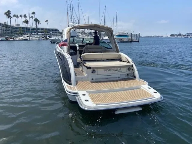  Yacht Photos Pics 2017 Formula 350 Sun Sport boat cruising in a marina.