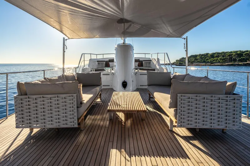 Sultana Yacht Photos Pics Luxurious deck of 1969 Feadship 25.8m yacht with elegant seating and ocean view.