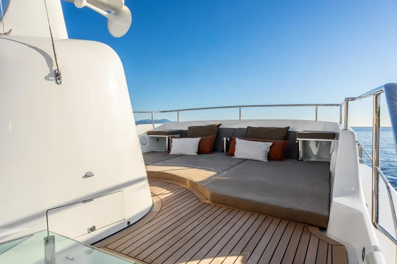 Sultana Yacht Photos Pics Luxurious deck of 1969 Feadship 25.8m yacht with sun loungers and ocean view.