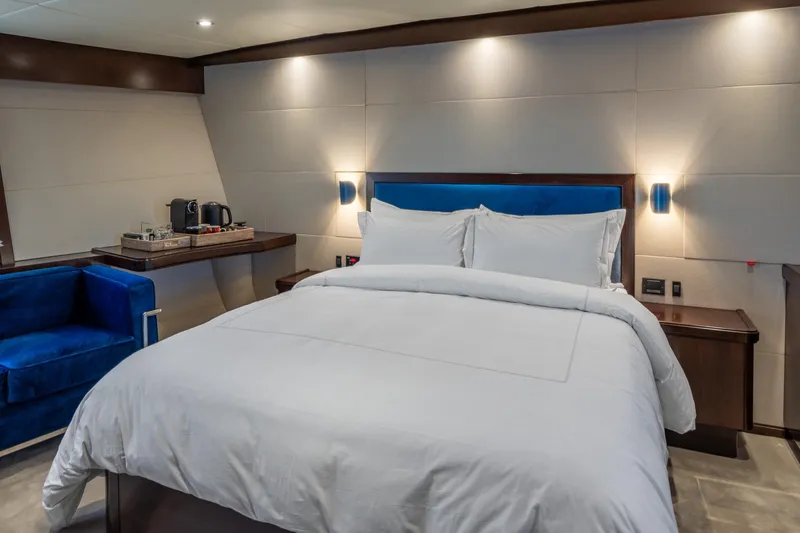 Sultana Yacht Photos Pics Luxurious bedroom interior on 1969 Feadship 25.8m yacht, featuring elegant bedding and modern amenities.