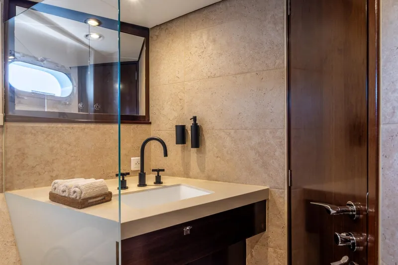 Sultana Yacht Photos Pics Luxurious bathroom on 1969 Feadship 25.8m yacht with modern sink and elegant fixtures.