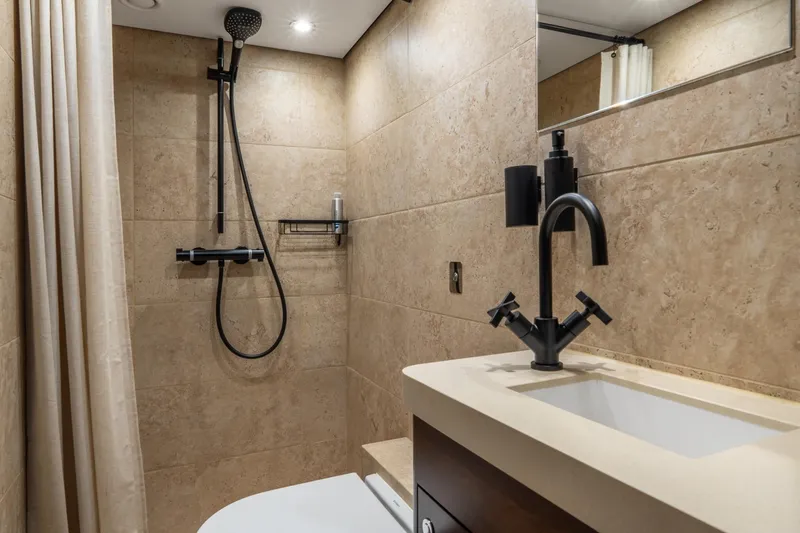 Sultana Yacht Photos Pics Luxurious bathroom on 1969 Feadship 25.8m yacht with modern fixtures and elegant design.