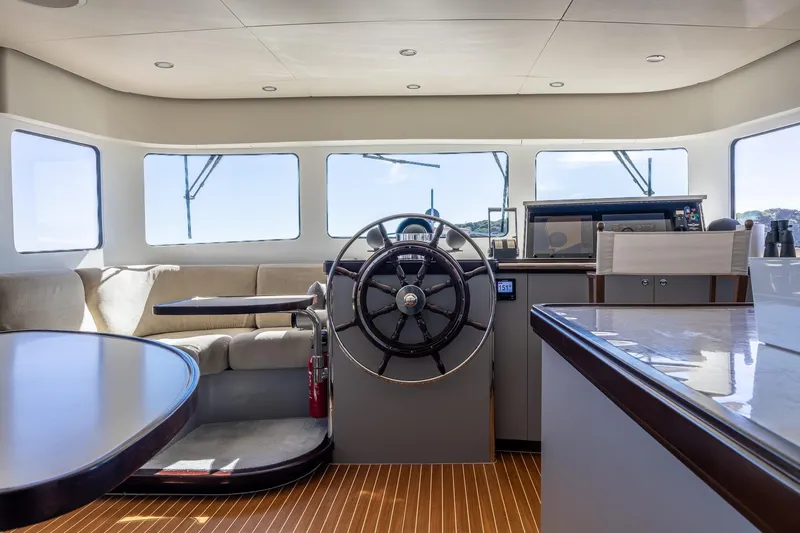 Sultana Yacht Photos Pics Luxurious interior of a 1969 Feadship 25.8m yacht with modern helm and seating area.