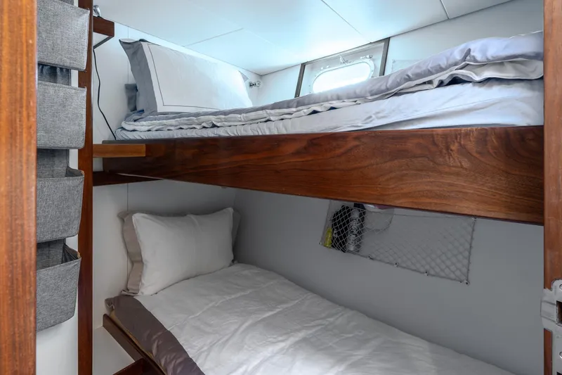 Sultana Yacht Photos Pics Bunk beds in a 1969 Feadship 25.8m yacht cabin with wooden accents.