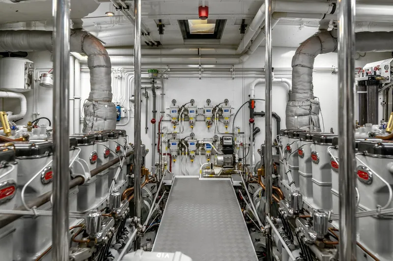 Sultana Yacht Photos Pics Engine room of a 1969 Feadship 25.8m yacht, showcasing machinery and piping.