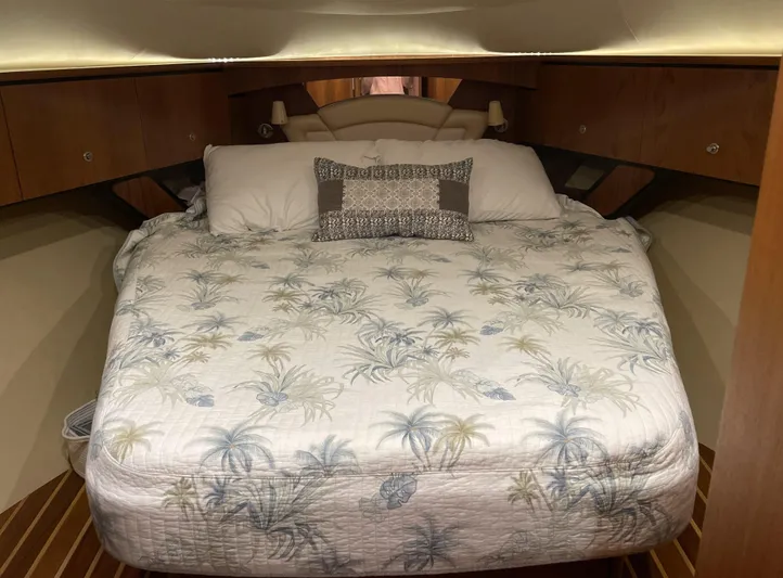Lion Around Yacht Photos Pics 2006 Tiara Yachts 4300 Sovran cabin with a cozy bed and tropical-themed bedding.
