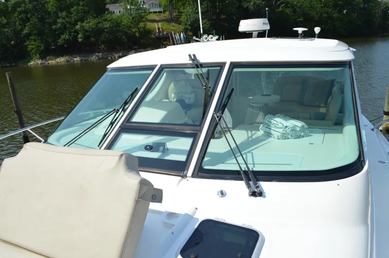 Lion Around Yacht Photos Pics 2006 Tiara Yachts 4300 Sovran with sleek windshield design, docked by a serene river.