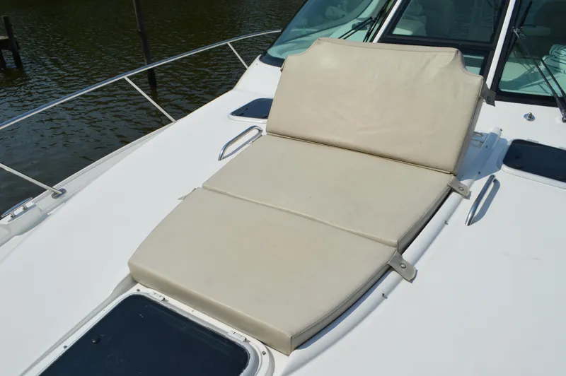 Lion Around Yacht Photos Pics 2006 Tiara Yachts 4300 Sovran sunpad on deck, featuring comfortable beige cushions.
