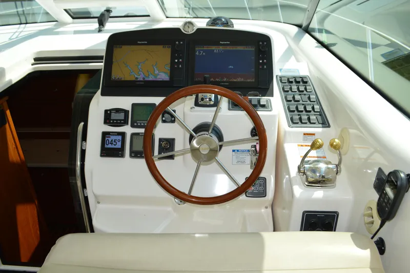 Lion Around Yacht Photos Pics 2006 Tiara Yachts 4300 Sovran helm with navigation screens and controls.