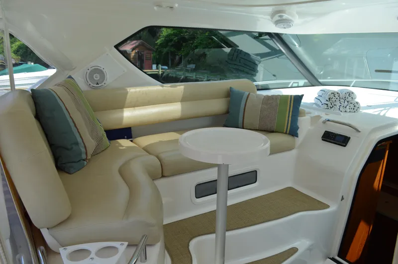 Lion Around Yacht Photos Pics 2006 Tiara Yachts 4300 Sovran interior with beige seating and striped cushions.