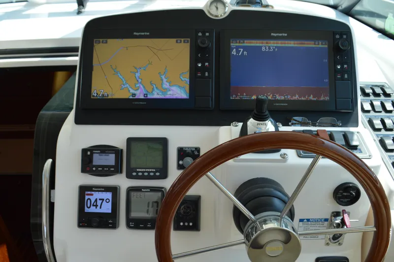 Lion Around Yacht Photos Pics 2006 Tiara Yachts 4300 Sovran helm with navigation screens and controls.