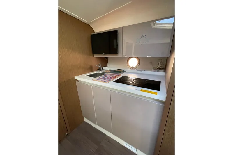  Yacht Photos Pics 2018 Benetau Gran Turismo 40 yacht kitchenette with modern appliances and sleek cabinetry.