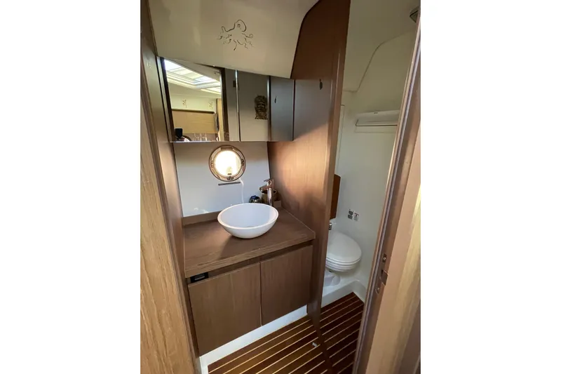  Yacht Photos Pics Bathroom interior of 2018 Benetau Gran Turismo 40 yacht with modern sink and porthole.