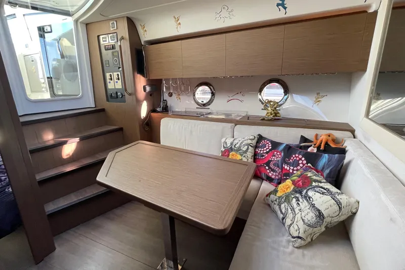  Yacht Photos Pics 2018 Benetau Gran Turismo 40 interior with cozy seating and nautical-themed decor.