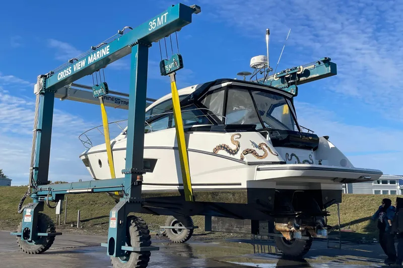  Yacht Photos Pics 2018 Benetau Gran Turismo 40 yacht lifted by marine crane under blue sky.
