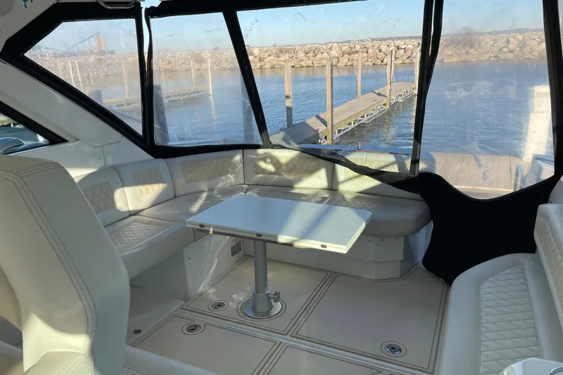  Yacht Photos Pics Interior of 2018 Benetau Gran Turismo 40 yacht with seating and table, dockside view.