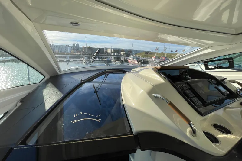  Yacht Photos Pics 2018 Benetau Gran Turismo 40 yacht interior with modern dashboard and marina view.